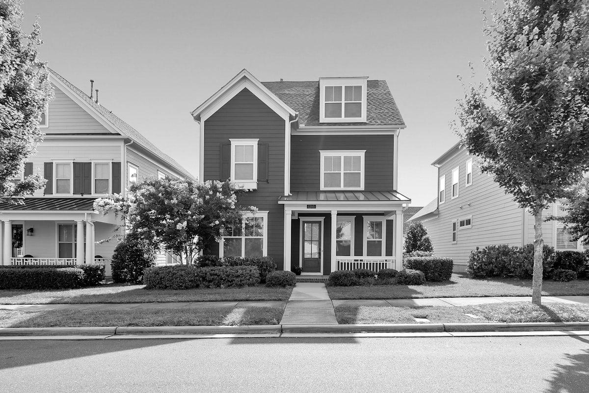 A street of two-story single-family houses with front porches